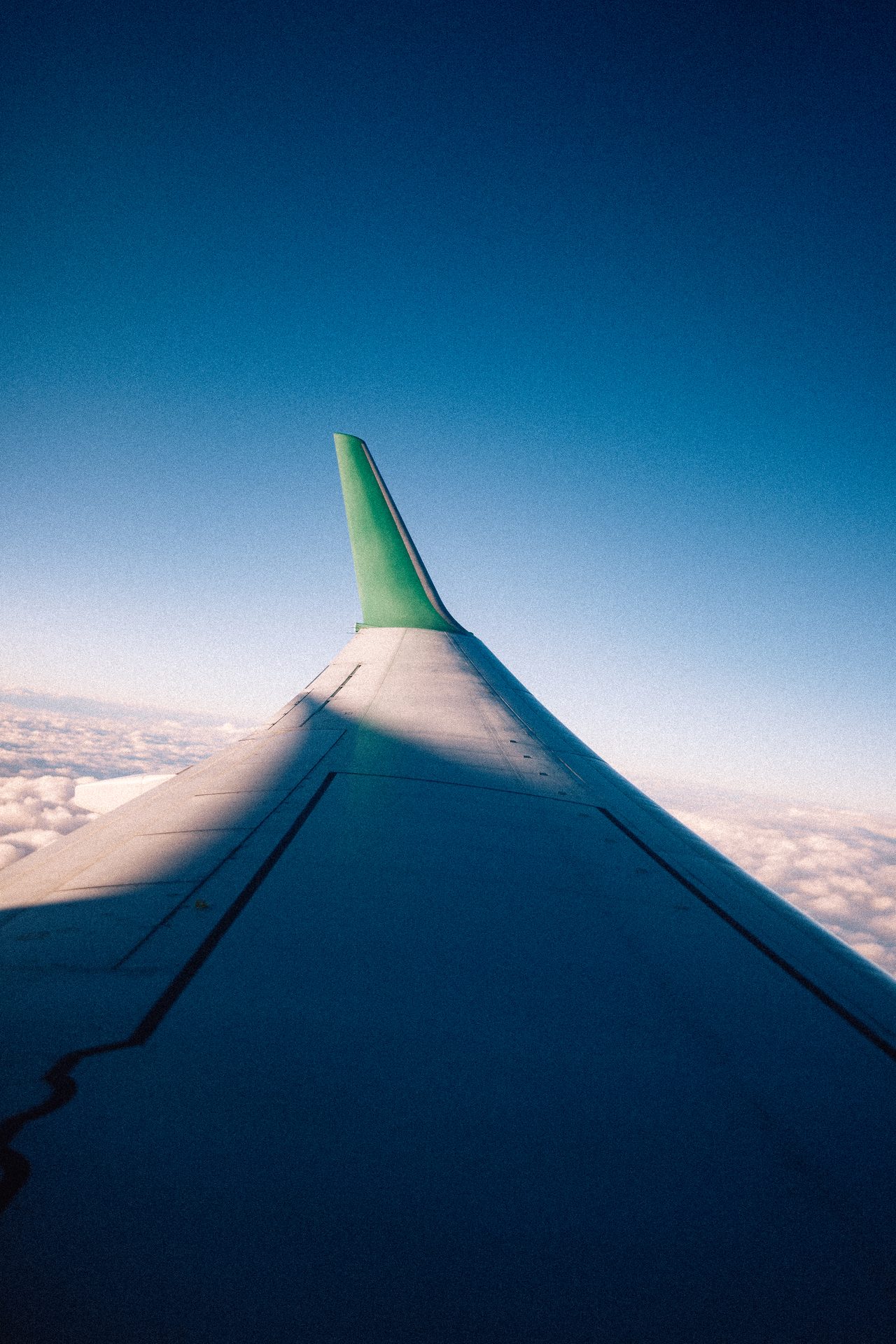 Flugzeugflügel vor einem klaren blauen Himmel